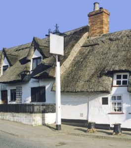 Thatched-roof country pub with white walls