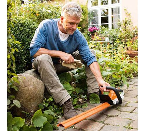 dnnfput5wuu.jpg - Mowers Online Man using axe to chop wood in garden